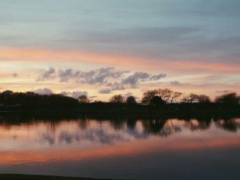 Scenic view of silhouette trees against sky at sunset