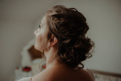 Rear view of shirtless woman at home