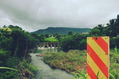 Scenic view of mountain against cloudy sky