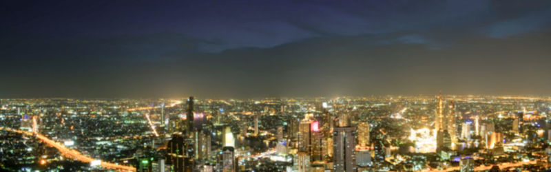 High angle view of illuminated modern buildings in city at night