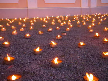 Illuminated candles burning in temple