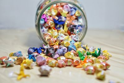 Close-up of colorful candies in jar on table