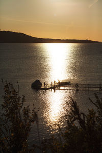 Scenic view of lake against sky during sunset