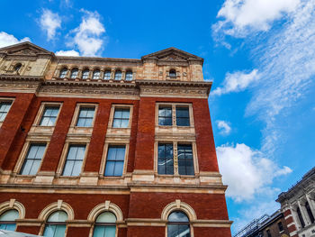 Low angle view of building against cloudy sky