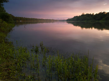 Scenic view of lake against sky at sunset
