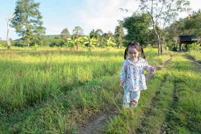 Full length of girl standing on field