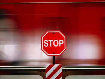 Road sign against blurred motion of train