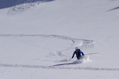 People skiing on snowcapped mountain