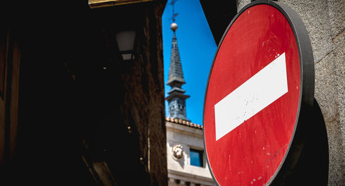 Low angle view of road sign against buildings