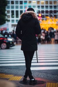 Rear view of man walking on street