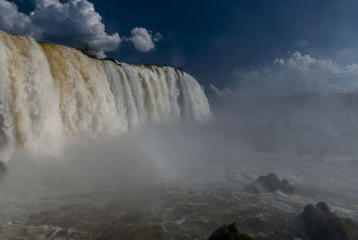 Panoramic view of waterfall against sky