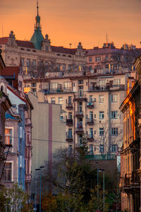 Buildings in city at sunset