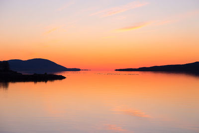 Scenic view of sea against romantic sky at sunset