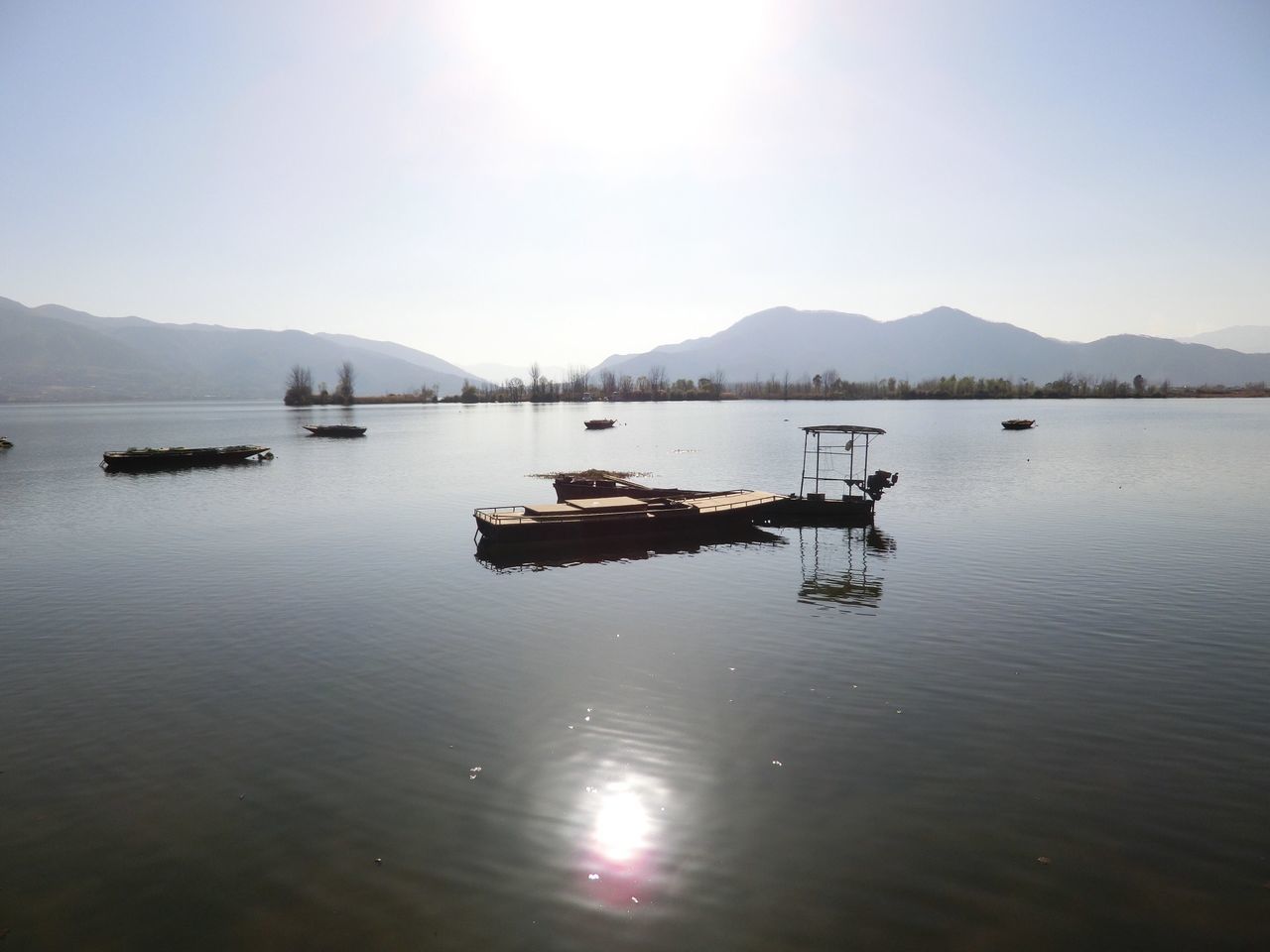 water, mountain, nautical vessel, reflection, transportation, tranquility, tranquil scene, mountain range, waterfront, scenics, lake, boat, beauty in nature, mode of transport, nature, clear sky, sunset, sky, idyllic, moored