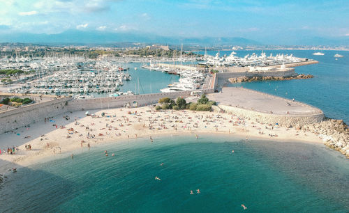 High angle view of cityscape by sea against sky