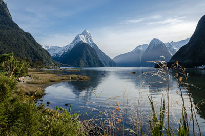 Scenic view of lake and mountains against sky