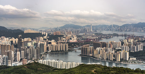 River amidst buildings in city against sky