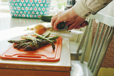 Close-up of person chopping vegetables on cutting board