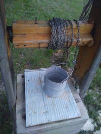 High angle view of wooden bench in field