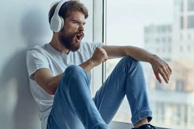 Side view of man exercising at home