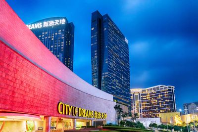 Low angle view of illuminated modern building against sky in city