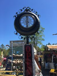 Low angle view of clock tower against blue sky