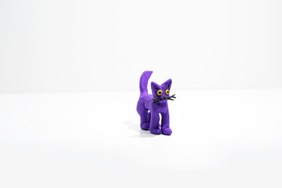 Close-up of purple toy against white background