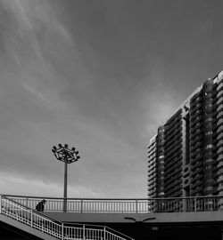 Low angle view of bridge and buildings against sky