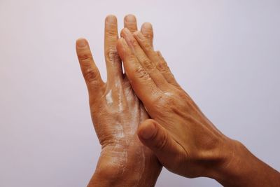 Close-up of human hand against white background