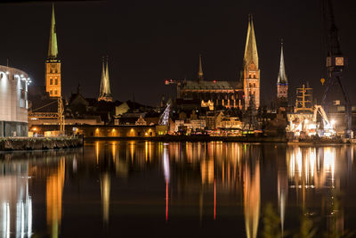 Reflection of illuminated buildings in city at night