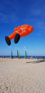 Scenic view of beach against blue sky