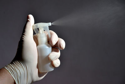 Close-up of human hand against black background