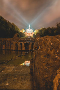 Illuminated buildings against sky in city