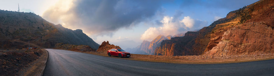 Panoramic shot of person riding motorcycle on road against sky