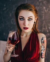 Close-up portrait of young woman drinking glasses