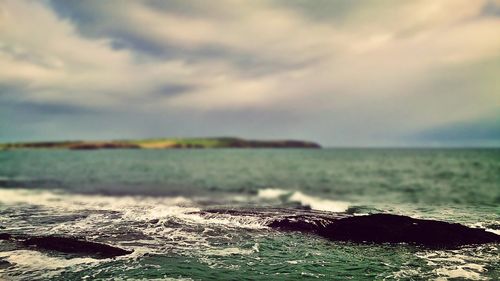 Scenic view of landscape against cloudy sky