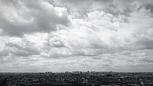 Cityscape against cloudy sky