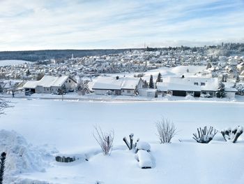 Scenic view of frozen landscape against sky during winter