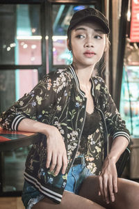 Portrait of young woman sitting outdoors