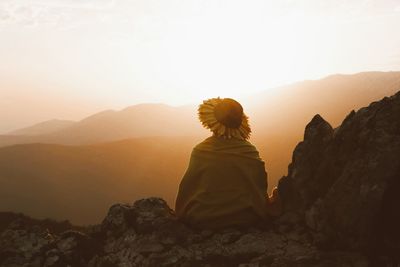 Rear view of woman standing on mountain