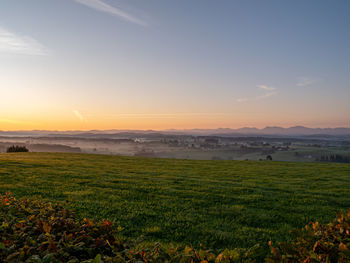 Scenic view of field against sky during sunset