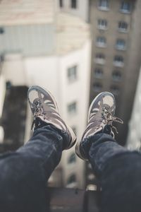 Low section of man standing on tiled floor