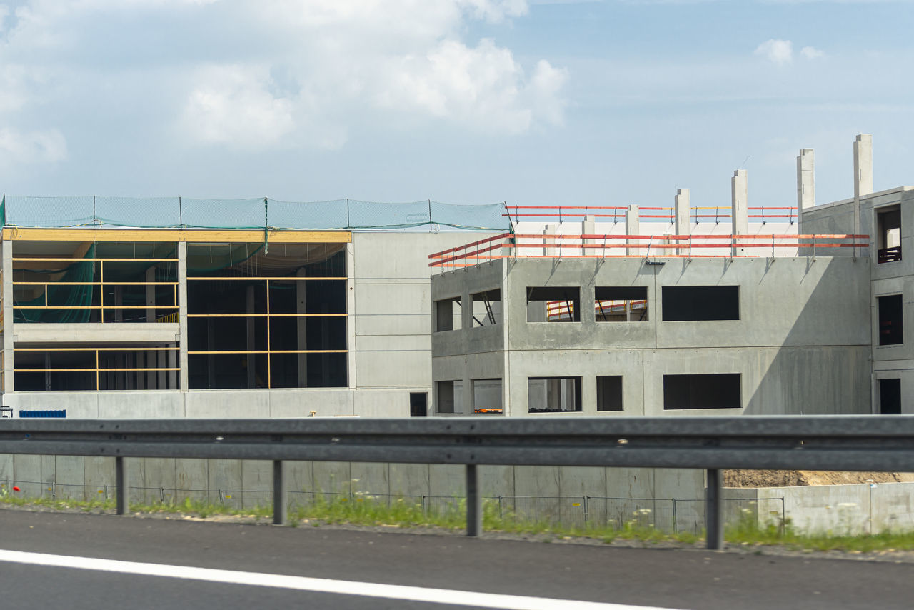 ROAD BY BUILDINGS AGAINST SKY