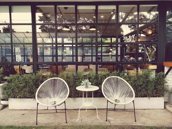 Table and chairs in yard against building
