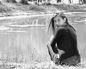 Portrait of woman sitting on field