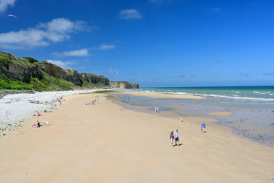 People on beach against sky