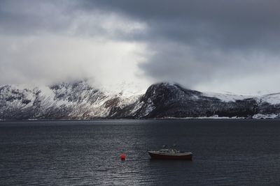 Scenic view of lake against sky during winter