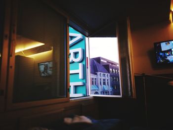 Close-up of illuminated text on window