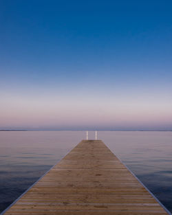 Pier over sea against clear sky