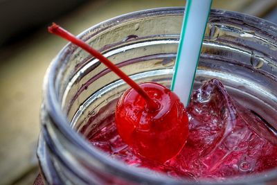 High angle view of drink with cherry in mason jar